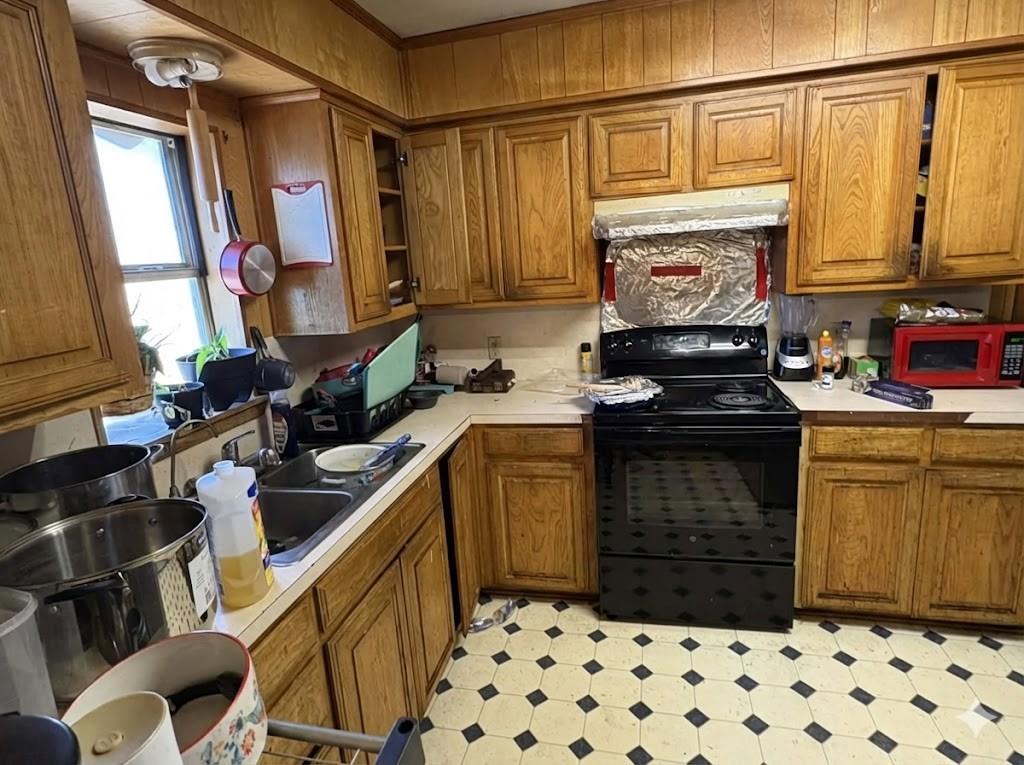 710 Shawnee Street Graham, TX 76450 - Photo 8 of 15 a kitchen with a refrigerator and a stove
