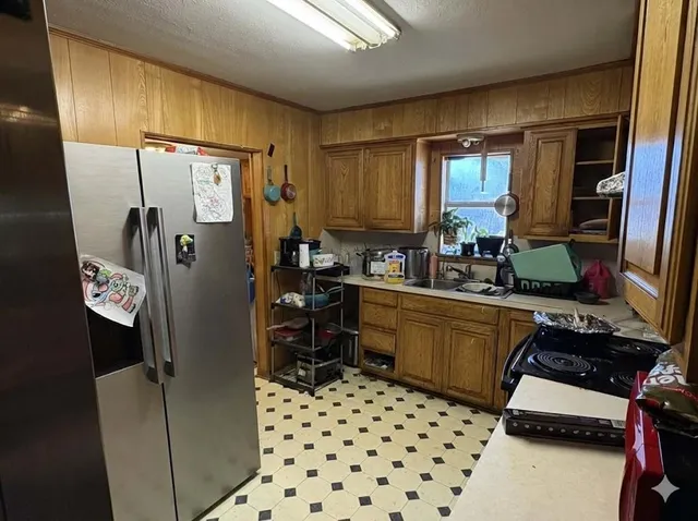 a kitchen with a refrigerator and a sink