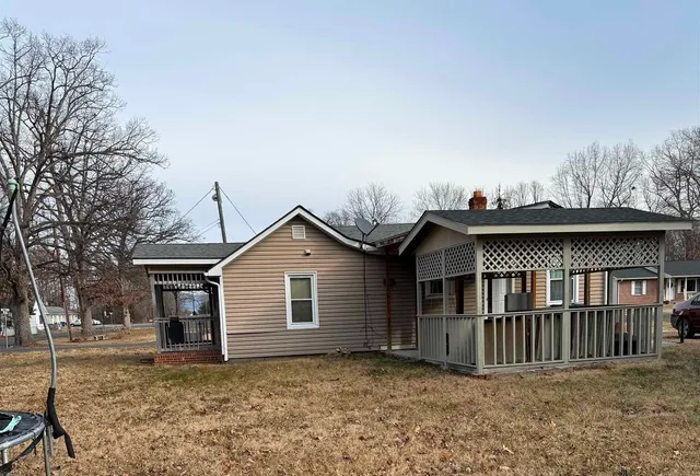 a view of a house with a wooden fence