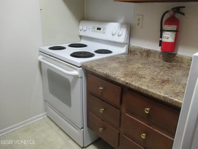 a bathroom with a granite countertop shower and a sink