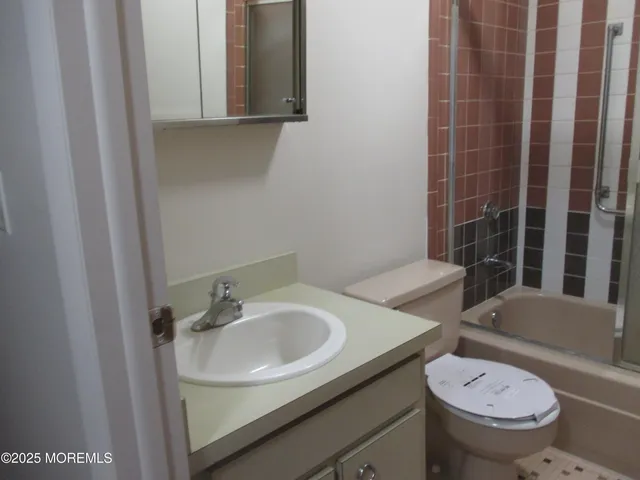 a view of an empty room with closet and window
