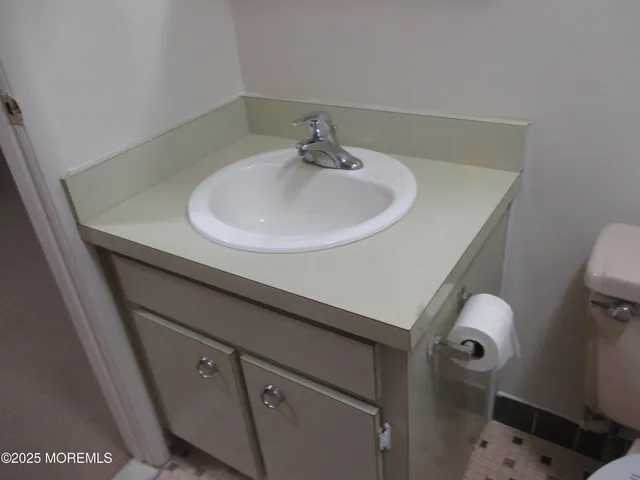 a bathroom with a granite countertop shower and a toilet