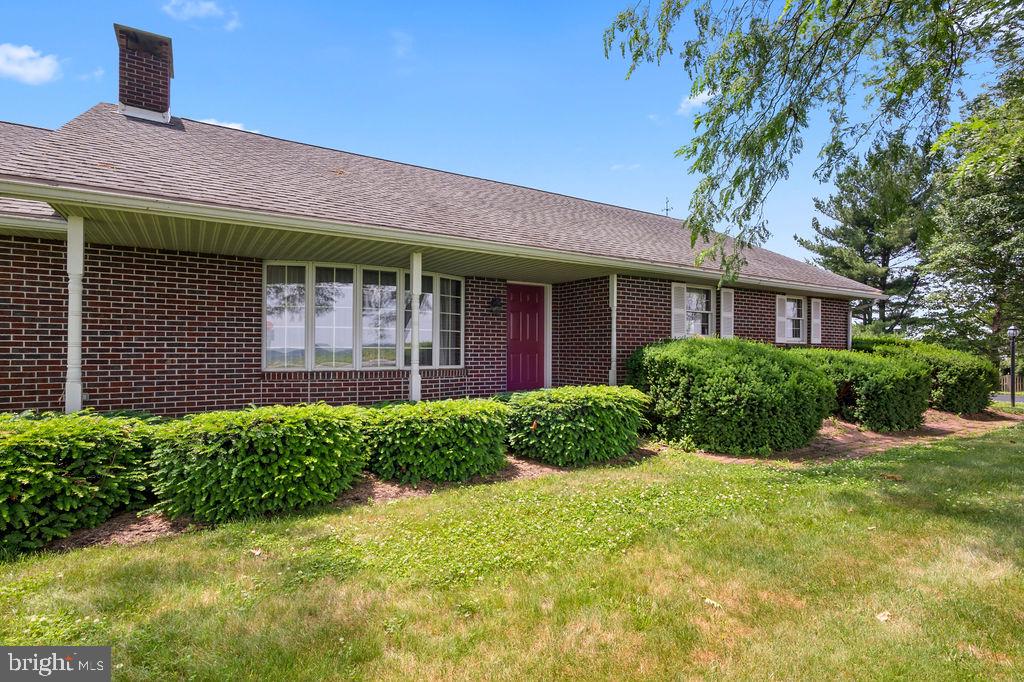 350 Big Spring Road Robesonia, PA 19551 - Photo 3 of 55 Charming brick home with lush greenery.