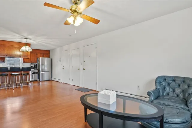 a living room with furniture and kitchen view