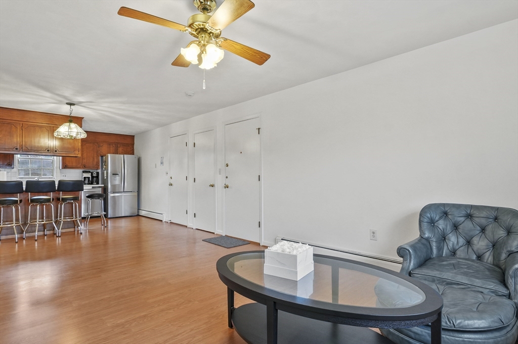 132 Parker Street, Unit G5 Acton, MA 01720 - Photo 11 of 22 a living room with furniture and kitchen view
