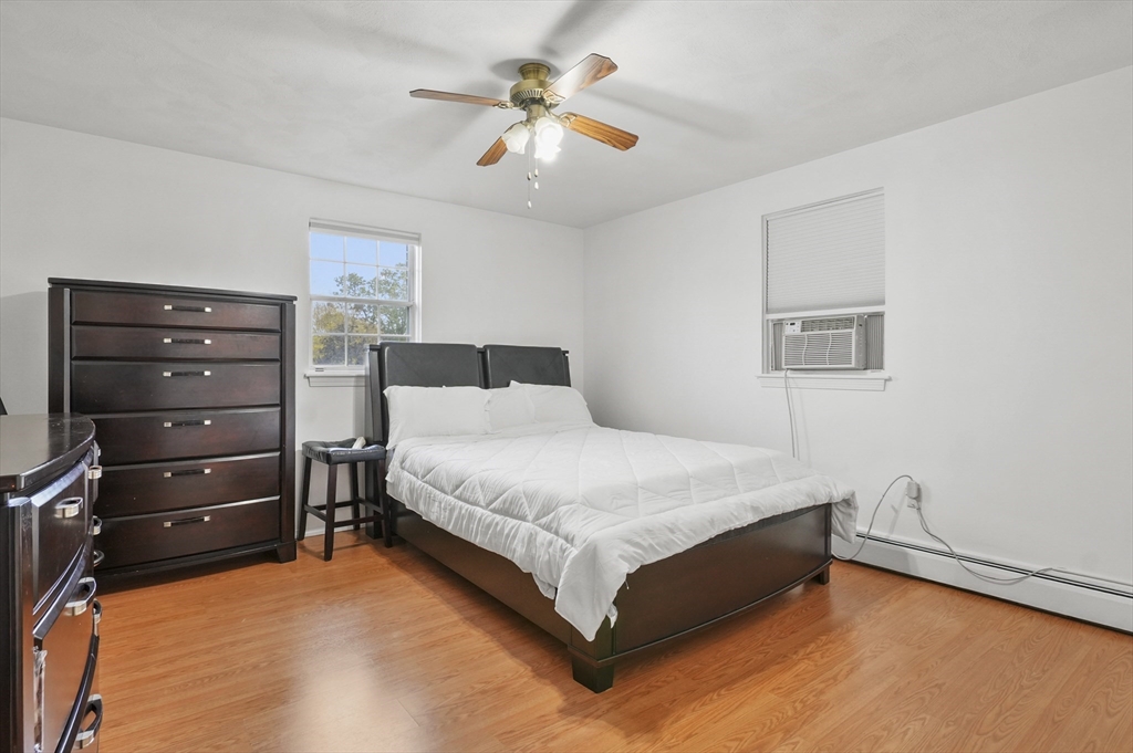132 Parker Street, Unit G5 Acton, MA 01720 - Photo 13 of 22 a bedroom with a bed and a ceiling fan