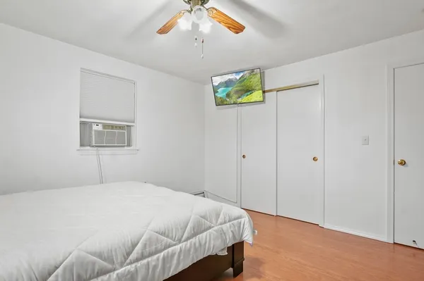 a bedroom with a bed and a window