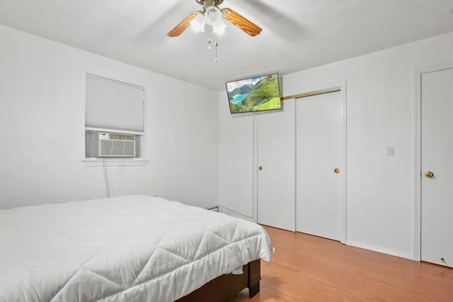 a bedroom with a bed and a window