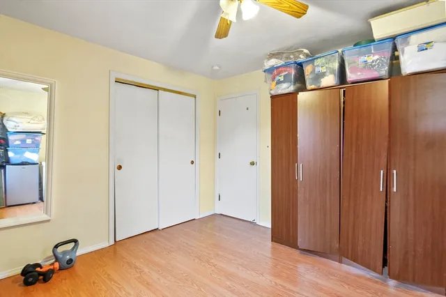 a bedroom with a bed and cabinets