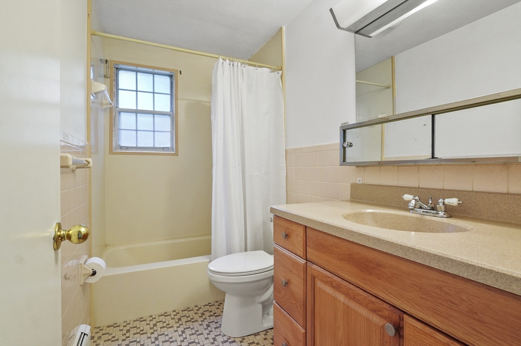 132 Parker Street, Unit G5 Acton, MA 01720 - Photo 17 of 22 a bathroom with a sink a toilet and shower