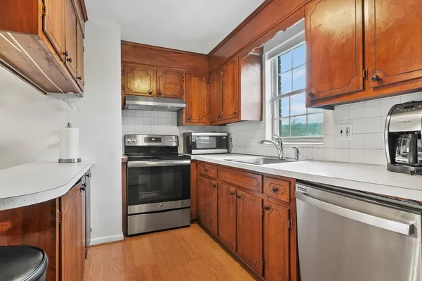 a kitchen with stainless steel appliances a stove sink and cabinets