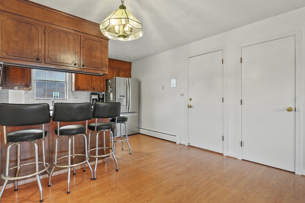 132 Parker Street, Unit G5 Acton, MA 01720 - Photo 7 of 22 a view of a dining room with furniture and chandelier