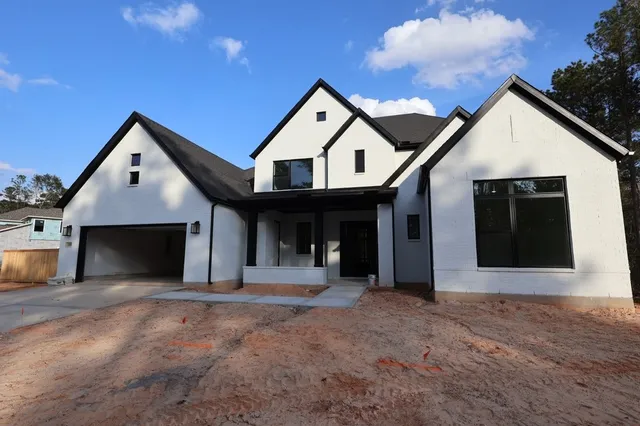 a view of a house with a yard and garage