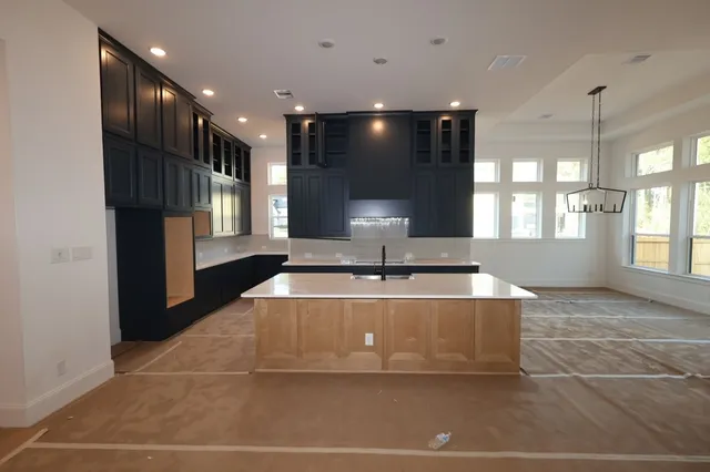 a view of a kitchen with a sink and a large window