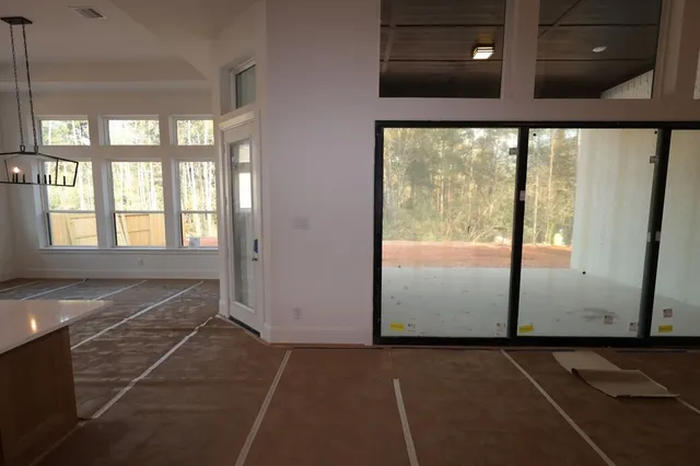 a view of an empty room with glass door