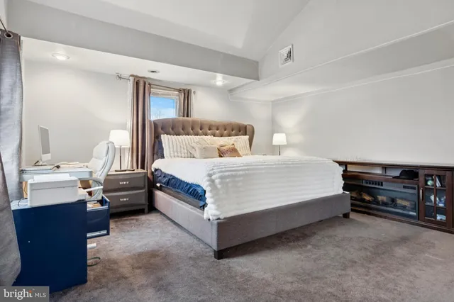 a bedroom with a bed and a night stand