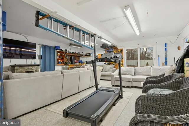 a living room with furniture a rug and a chandelier