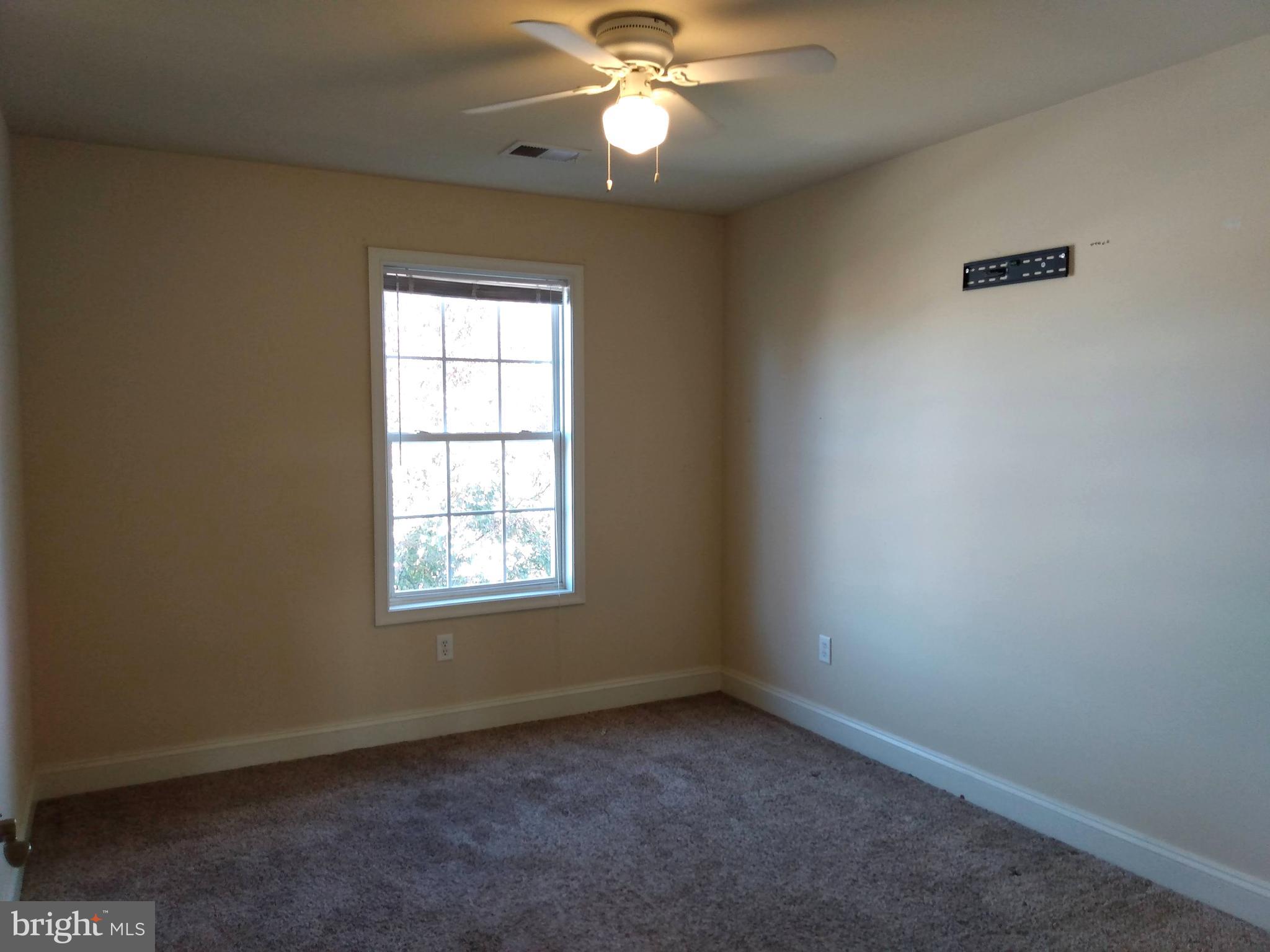 237 Whitley Chambersburg, PA 17201 - Photo 16 of 23 an empty room with a window and a fan