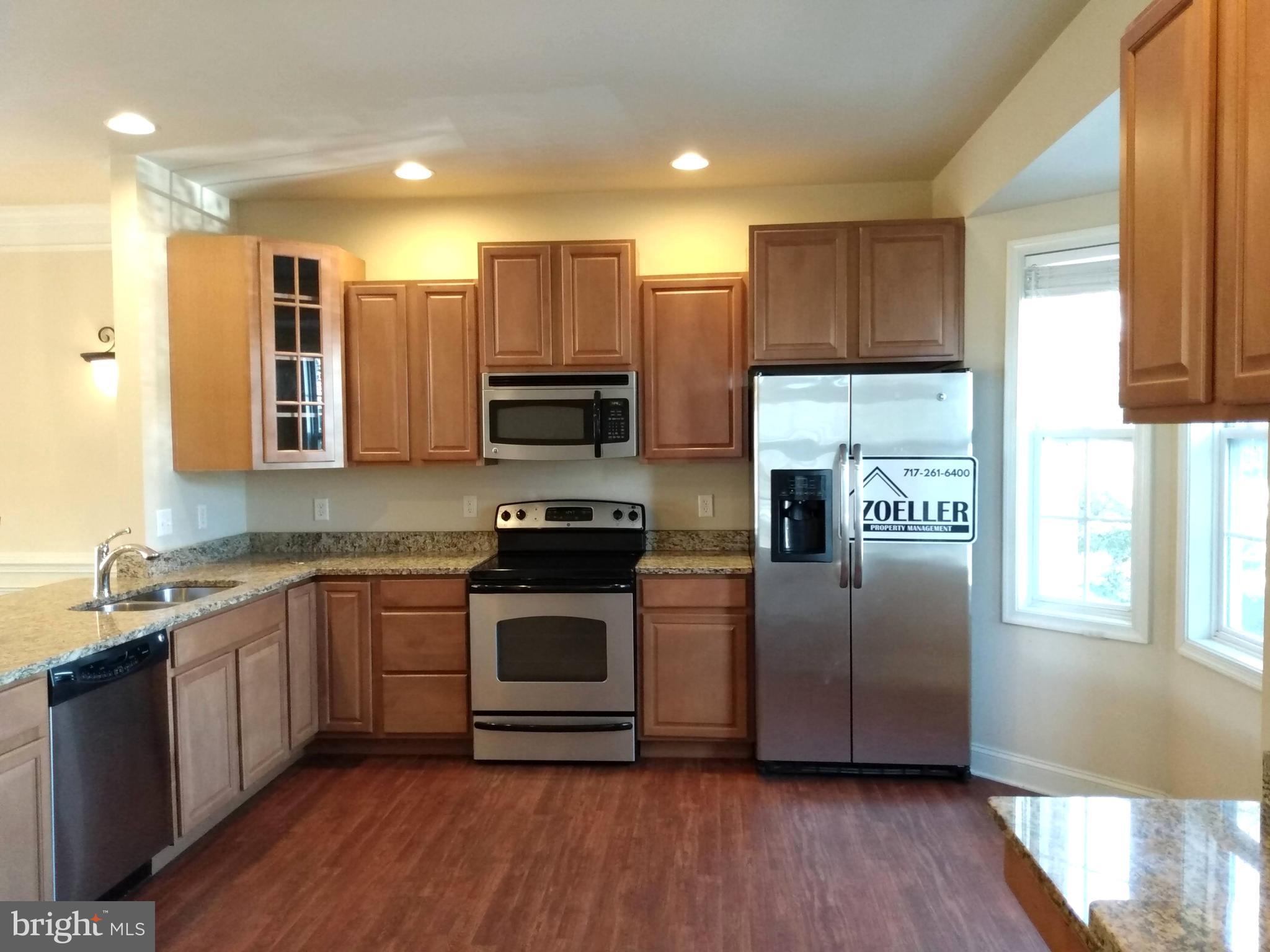 237 Whitley Chambersburg, PA 17201 - Photo 3 of 23 a kitchen with stainless steel appliances a stove a sink a refrigerator and cabinets