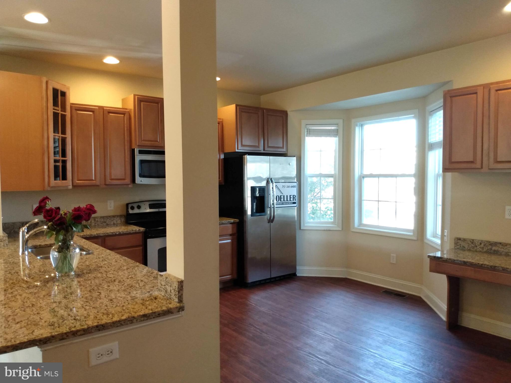 237 Whitley Chambersburg, PA 17201 - Photo 4 of 23 a kitchen with stainless steel appliances granite countertop a sink stove and refrigerator