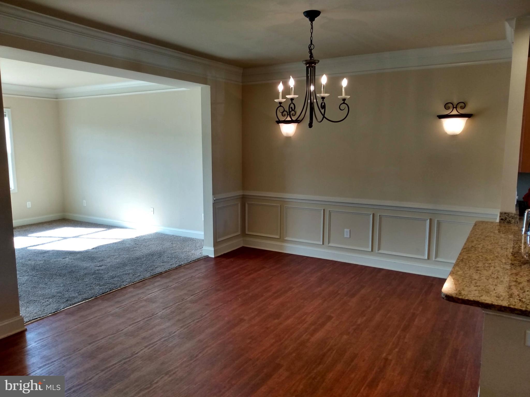 237 Whitley Chambersburg, PA 17201 - Photo 6 of 23 a view of empty room with wooden floor and kitchen view
