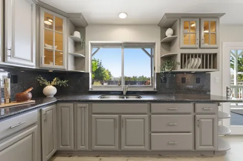 a kitchen with white cabinets and a sink