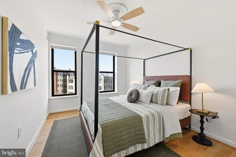 a bedroom with a bed and a mirror