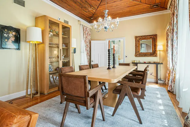 a view of a hallway with furniture and a potted plant