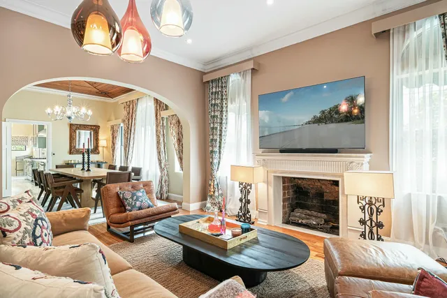 a room with table chairs and a chandelier