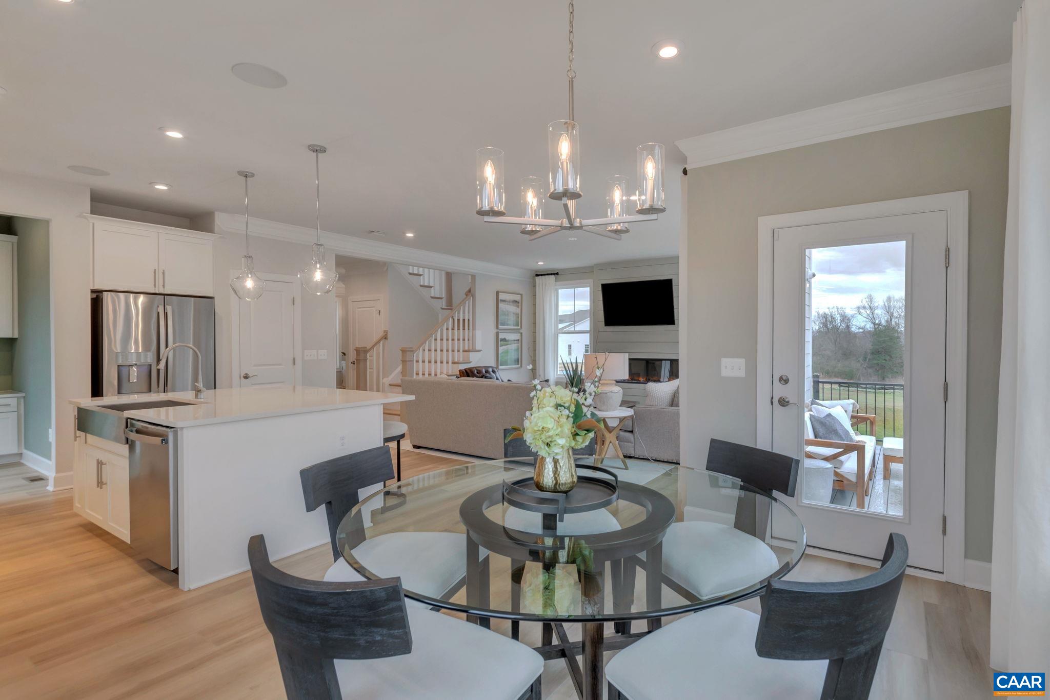 3059 Rambling Brk Lane Crozet, VA 22932 - Photo 9 of 30 a view of a dining room with furniture a kitchen and chandelier
