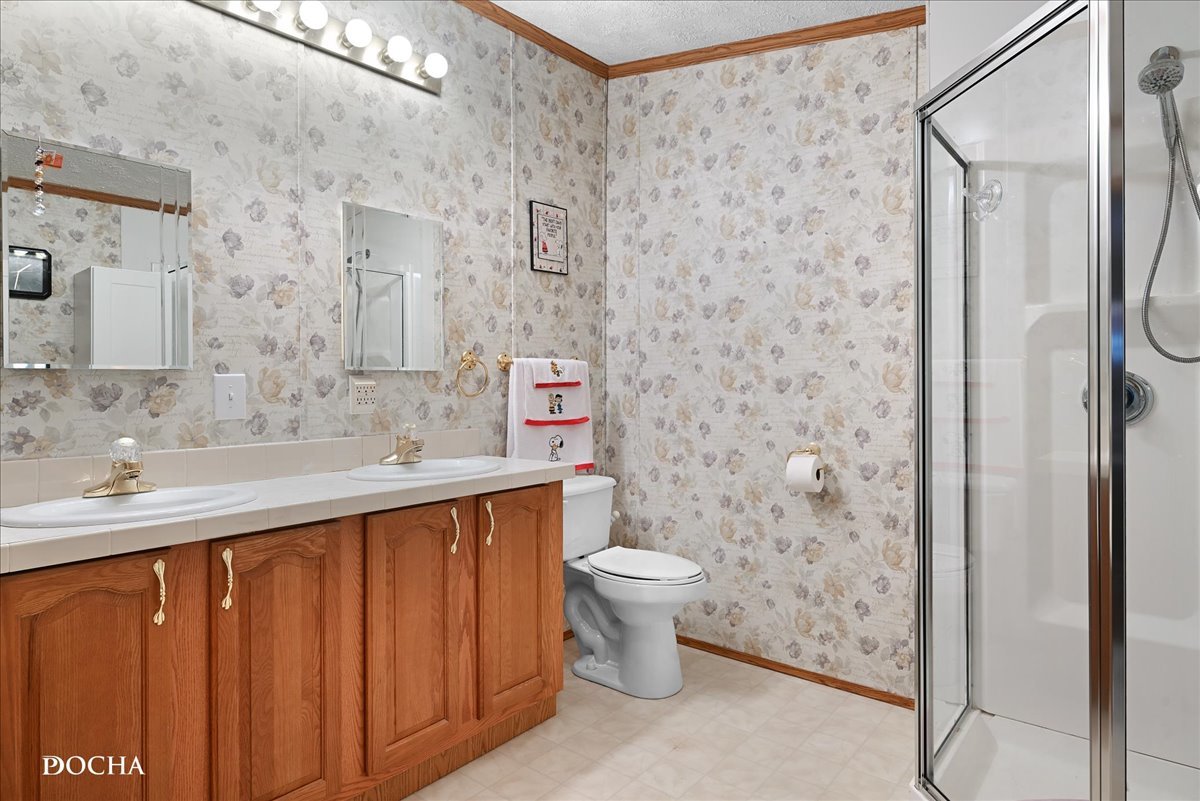 614 Morgan Road Amboy, IL 61310 - Photo 9 of 18 a bathroom with a sink a toilet and shower