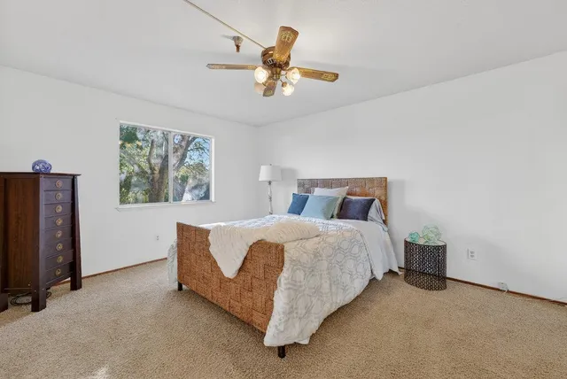 a bedroom with bed and window