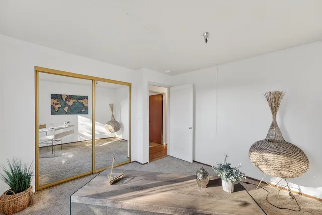 a bedroom with a bed and glass windows