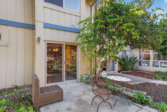 a view of a house with a big yard and large trees