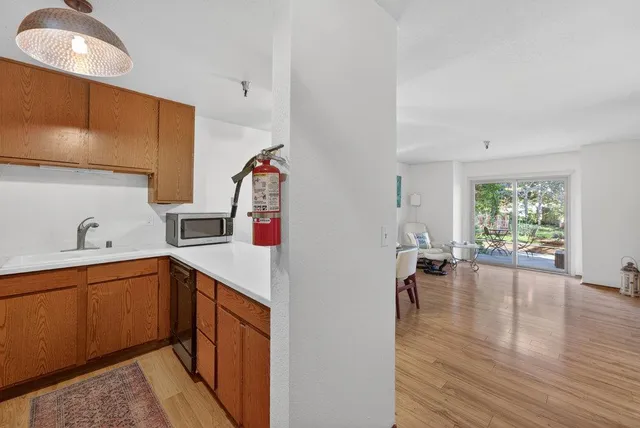 a kitchen with a sink cabinets and window