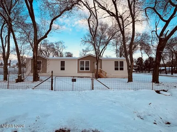 a view of a house with a tree in the background