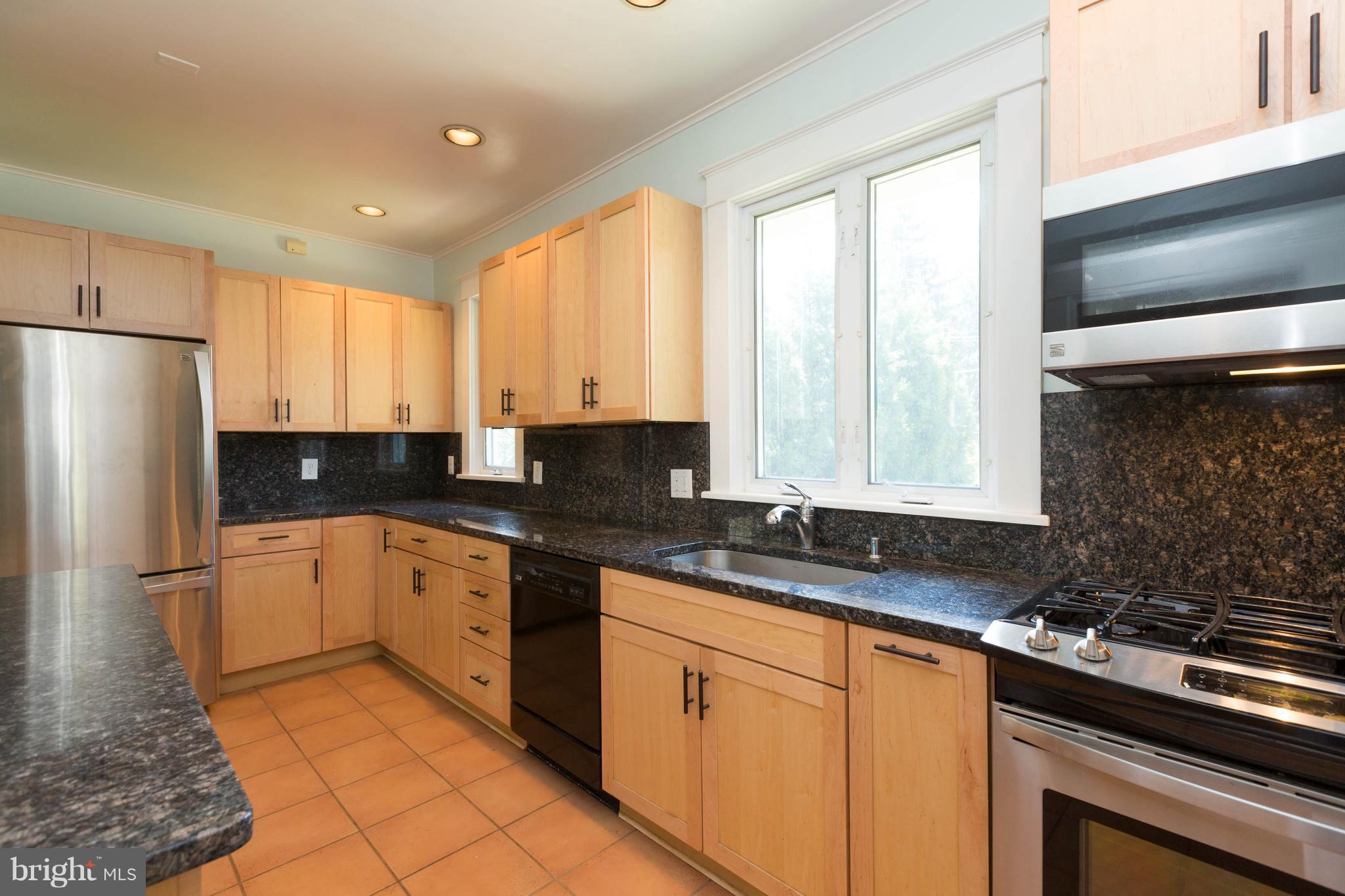 2219 Crest Road Baltimore, MD 21209 - Photo 11 of 30 Kitchen with granite counters and maple cabinetry