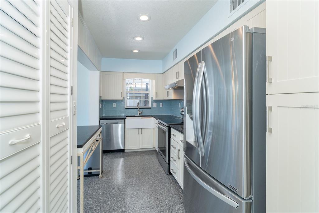 2835 North Beach Road, Unit A Englewood, FL 34223 - Photo 13 of 58 a kitchen with a refrigerator and a sink