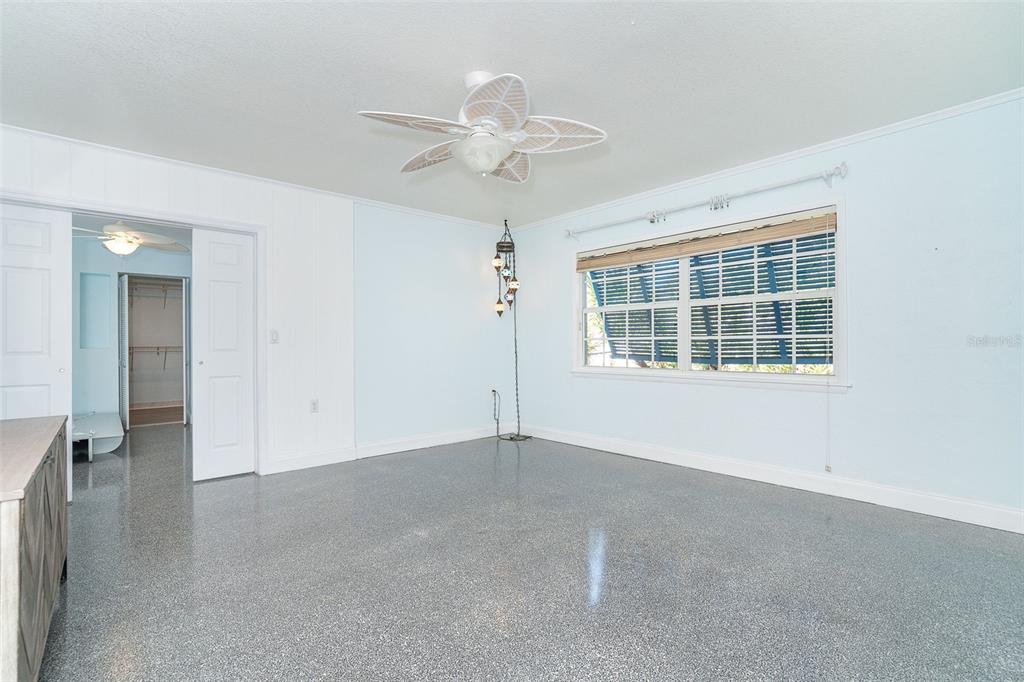 2835 North Beach Road, Unit A Englewood, FL 34223 - Photo 19 of 58 an empty room with windows and chandelier fan