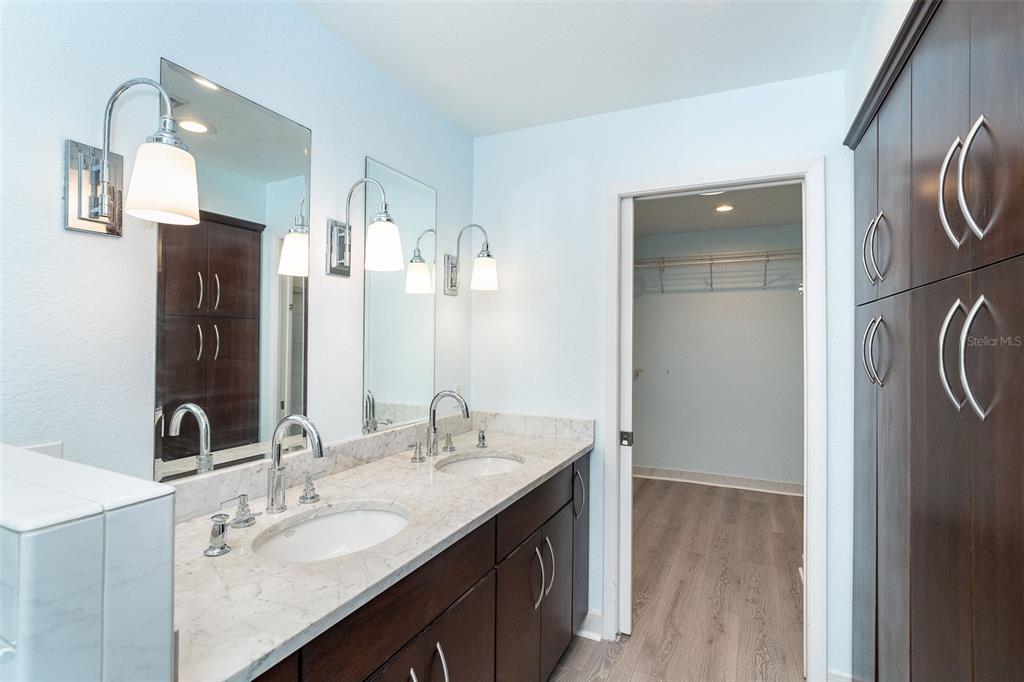 2835 North Beach Road, Unit A Englewood, FL 34223 - Photo 22 of 58 a bathroom with a double vanity sink and mirror
