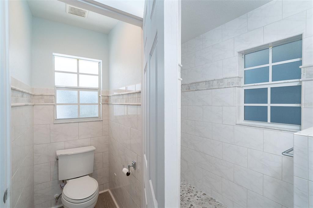 2835 North Beach Road, Unit A Englewood, FL 34223 - Photo 23 of 58 a white toilet sitting next to a bathroom sink