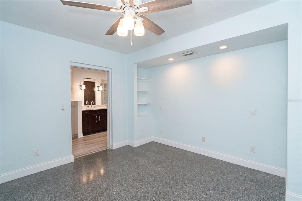 2835 North Beach Road, Unit A Englewood, FL 34223 - Photo 25 of 58 an empty room with a bathroom and a chandelier fan