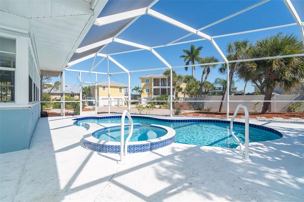 2835 North Beach Road, Unit A Englewood, FL 34223 - Photo 32 of 58 a view of a patio with a table and chairs
