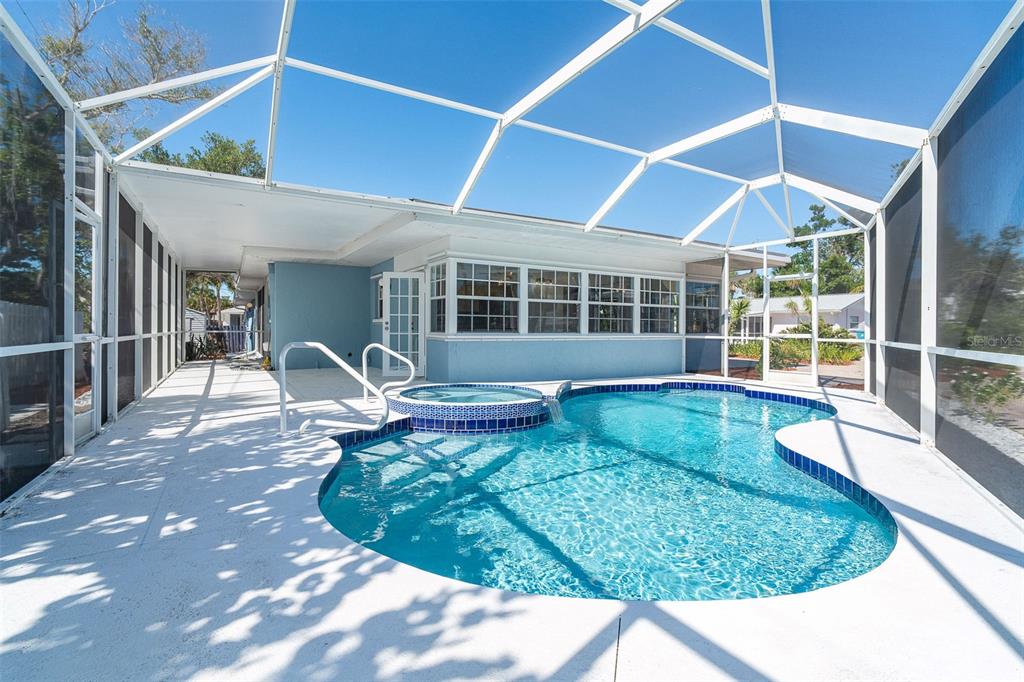 2835 North Beach Road, Unit A Englewood, FL 34223 - Photo 33 of 58 a view of a house with backyard sitting area and porch
