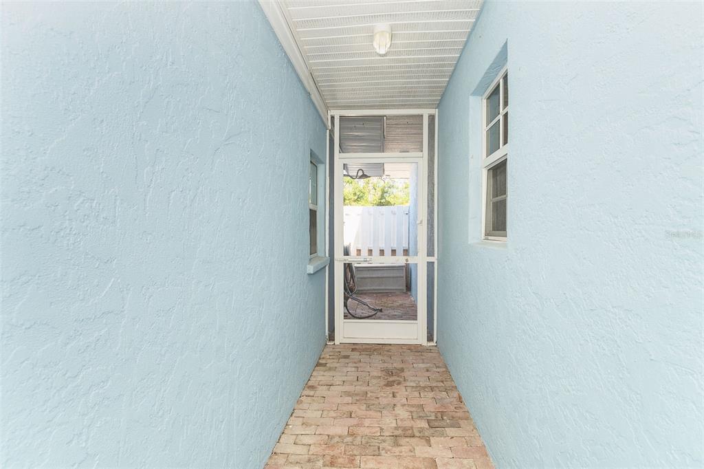 2835 North Beach Road, Unit A Englewood, FL 34223 - Photo 38 of 58 a view of a hallway with wooden floor and a bathroom