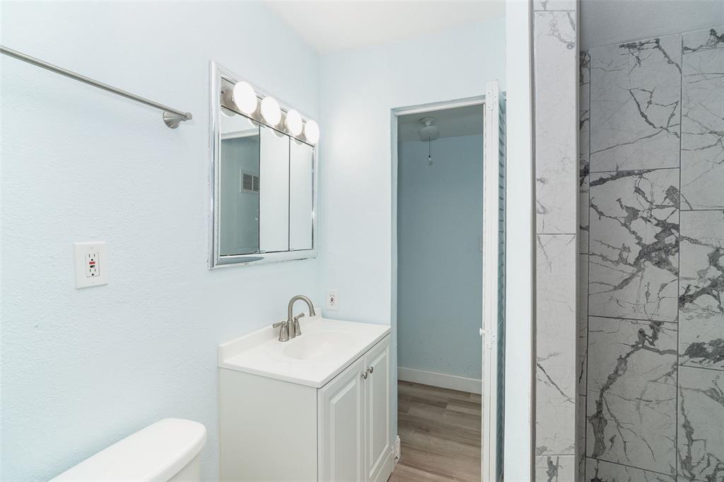 2835 North Beach Road, Unit A Englewood, FL 34223 - Photo 43 of 58 a bathroom with a toilet sink and shower