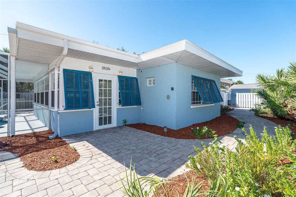2835 North Beach Road, Unit A Englewood, FL 34223 - Photo 10 of 58 a front view of a house with a yard
