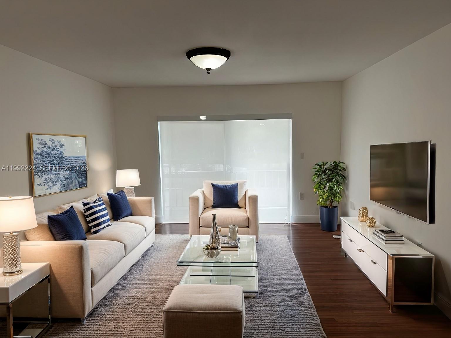 5400 Southwest 77th Court, Unit 2R Miami, FL 33155 - Photo 2 of 16 a living room with furniture and a flat screen tv