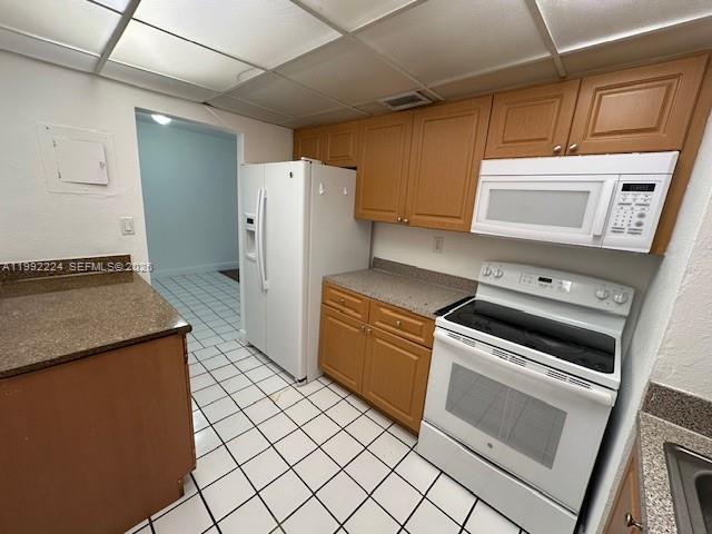 5400 Southwest 77th Court, Unit 2R Miami, FL 33155 - Photo 7 of 16 a kitchen with a stove cabinets and refrigerator