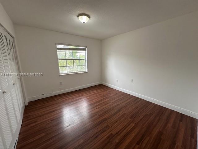 5400 Southwest 77th Court, Unit 2R Miami, FL 33155 - Photo 10 of 16 an empty room with wooden floor and windows